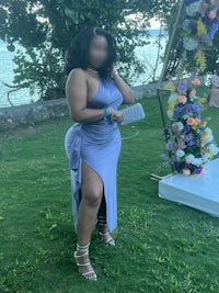 a woman in a purple dress posing for a photo